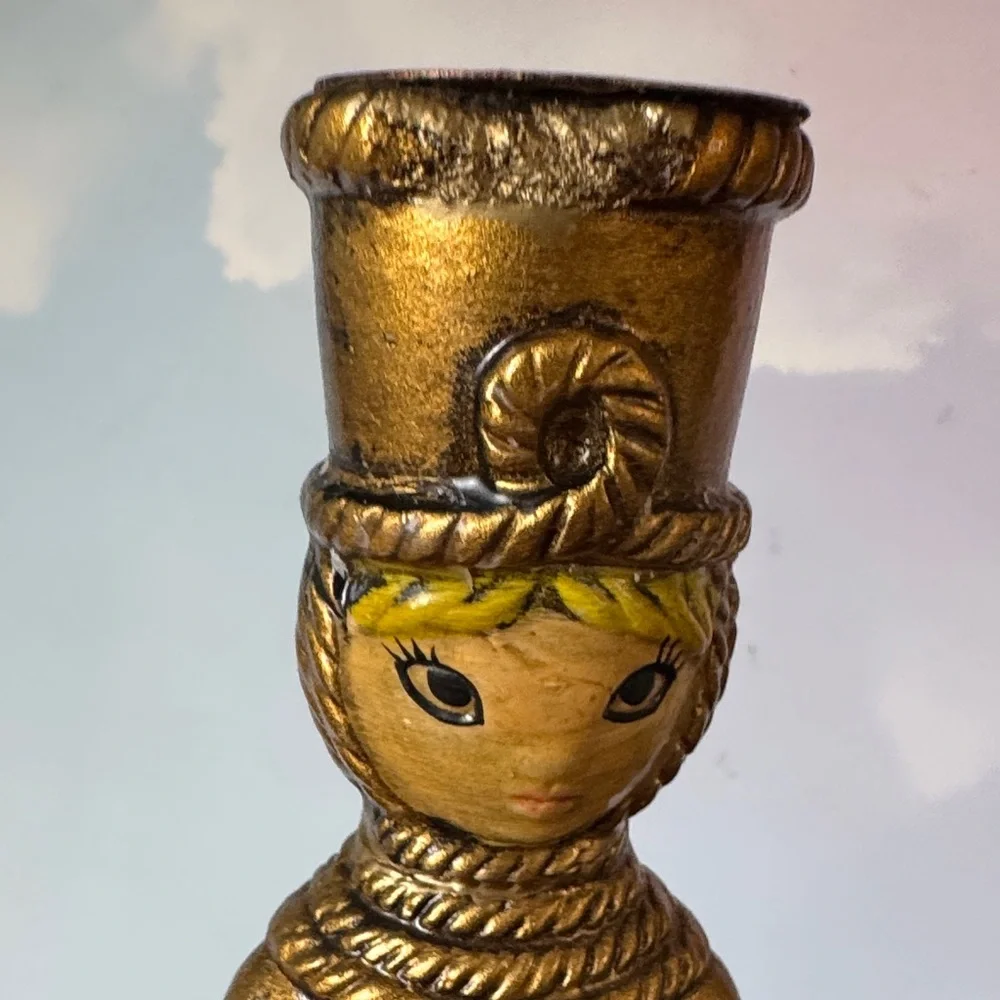vintage chalkware candle holder featuring a metallic gold-finished figure